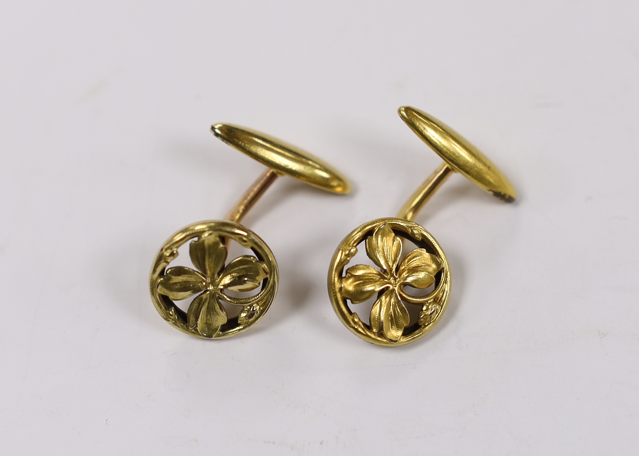 A pair of continental yellow metal overlaid circular cufflinks, of pierced foliate form, 14mm.